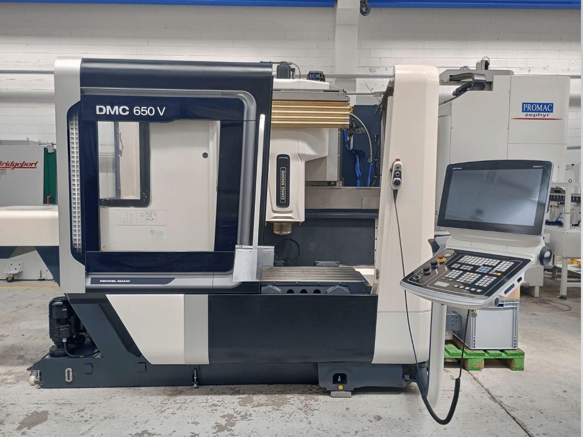 Верстат Decker Maho DMC 650 V з ЧПУ, вид збоку, з панеллю керування з кнопками та екраном, в промислових умовах.