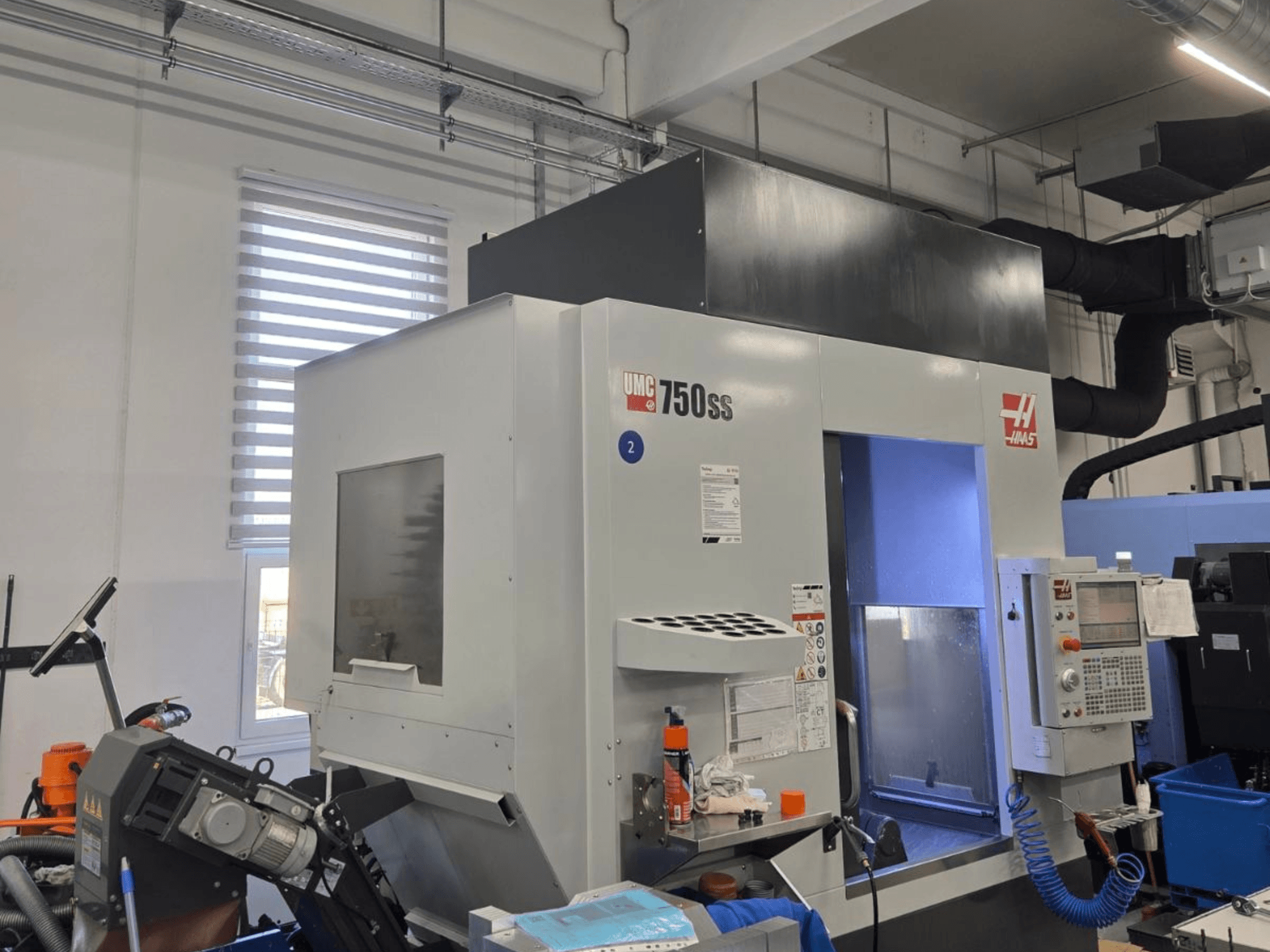 Вертикальний обробний центр Haas UMC-750SS, вид спереду, з панеллю керування та вільним доступом до зони обробки.