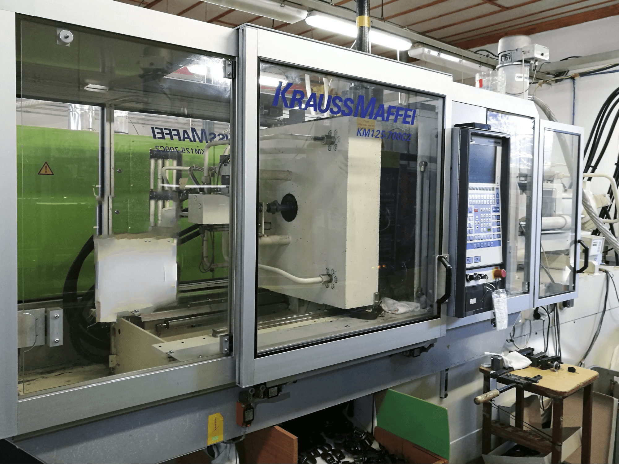 Left view of Krauss Maffei 125-700 C2 Machine