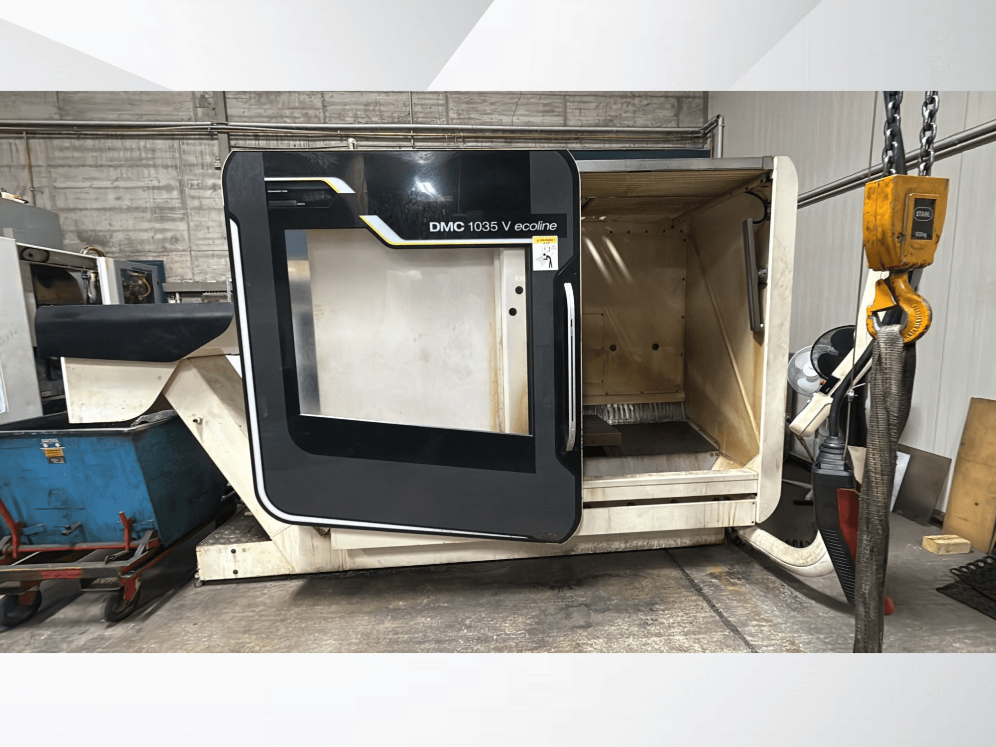 Верстат з ЧПК DMC 1035 V ecoline, вид спереду, з відкритими дверцятами, що відкривають порожній салон і панель керування.