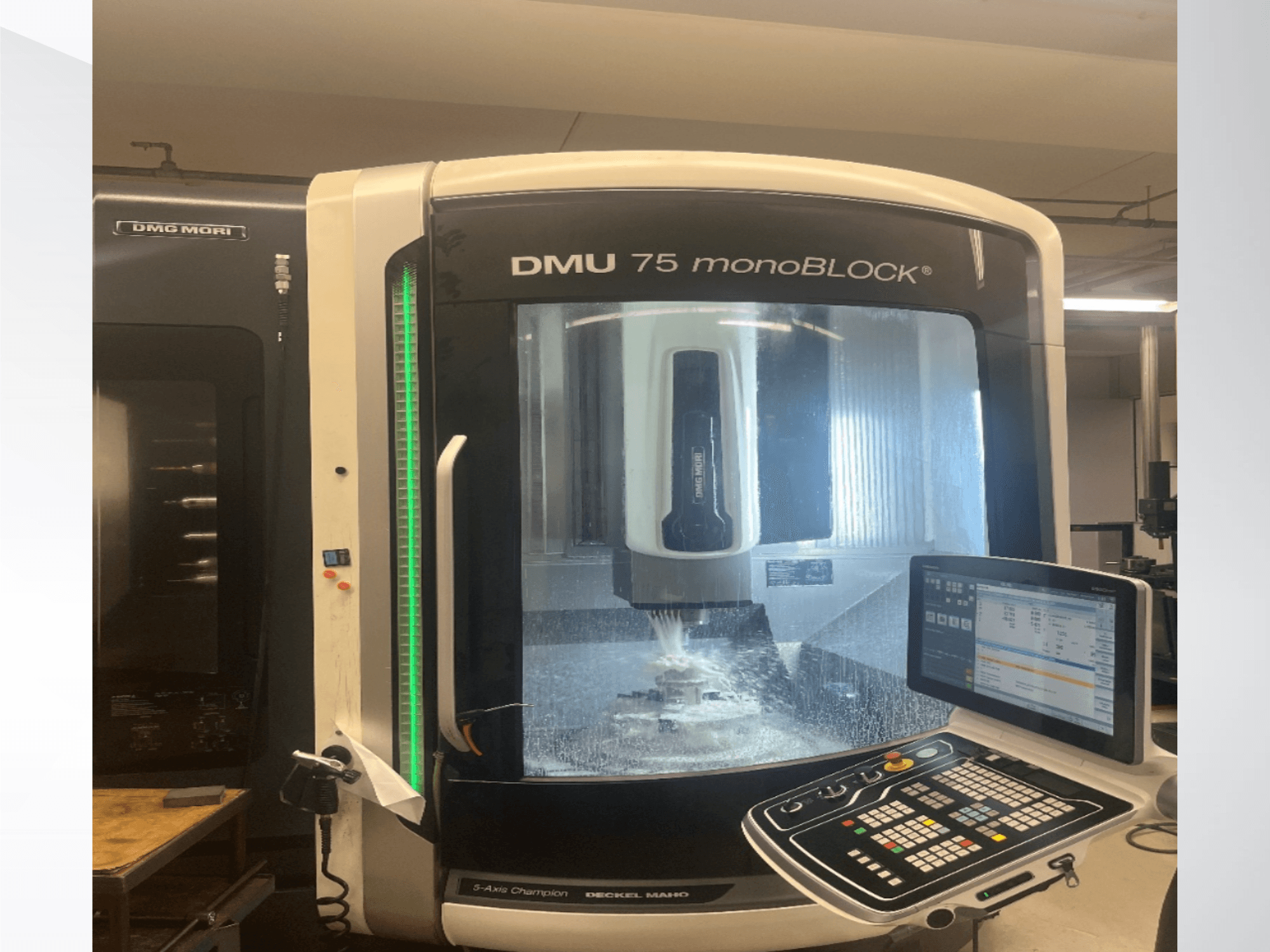 Універсальний обробний центр DMG MORI DMU 75 monoBLOCK у фронтальному ракурсі, на якому видно панель управління та зону фрезерування.