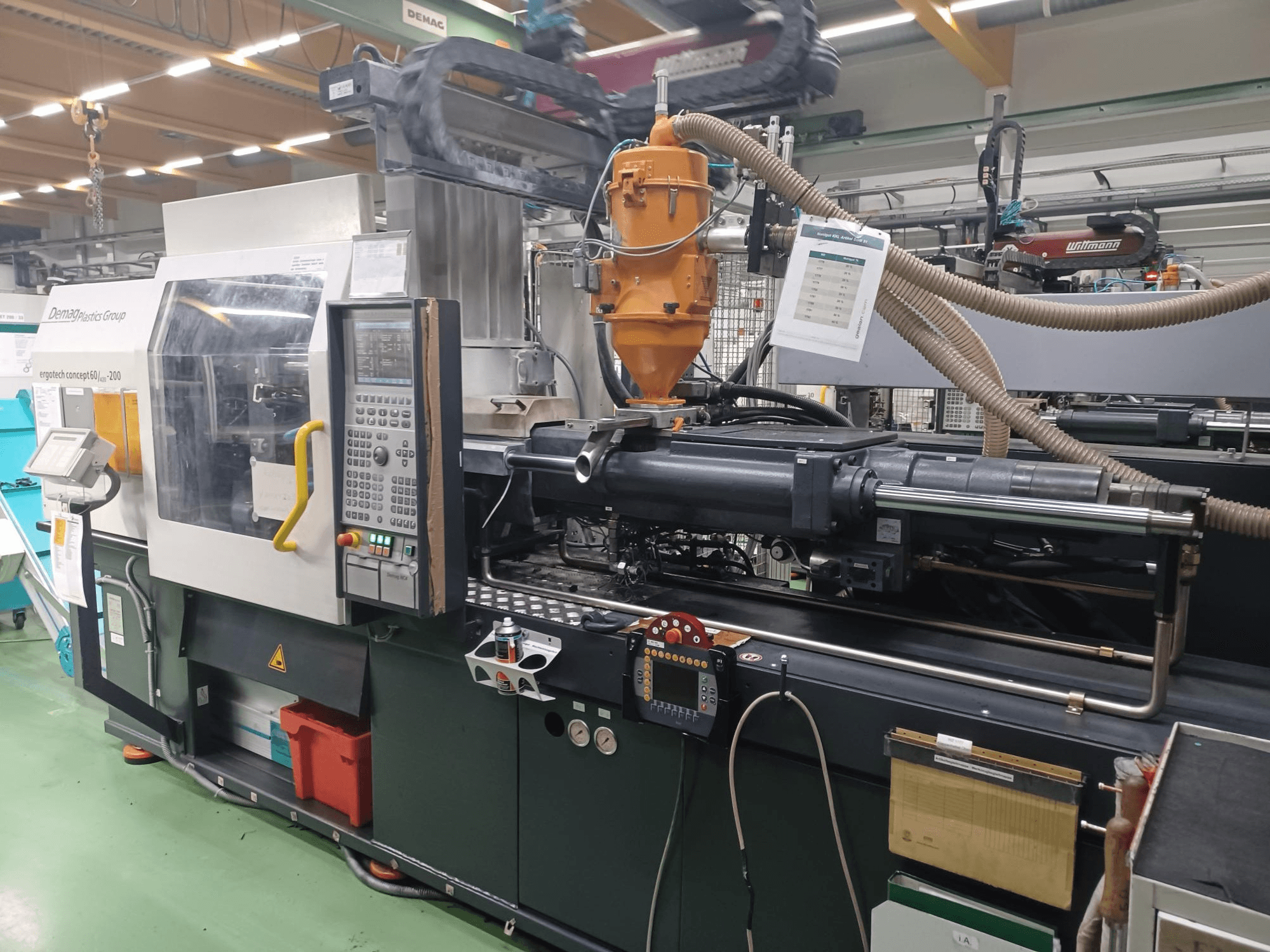 Термопластавтомат Demag Ergotech 200, вид спереду, з панеллю керування, соплом і робочими компонентами.