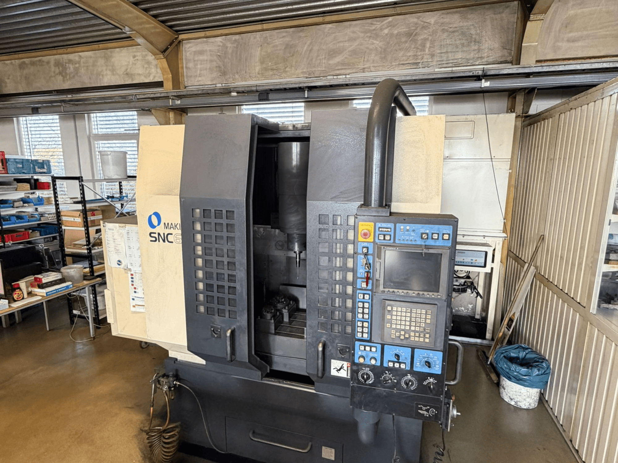 Вертикальний обробний центр Makino SNC 64-A15 спереду, з панеллю керування, зоною обробки та робочим простором.