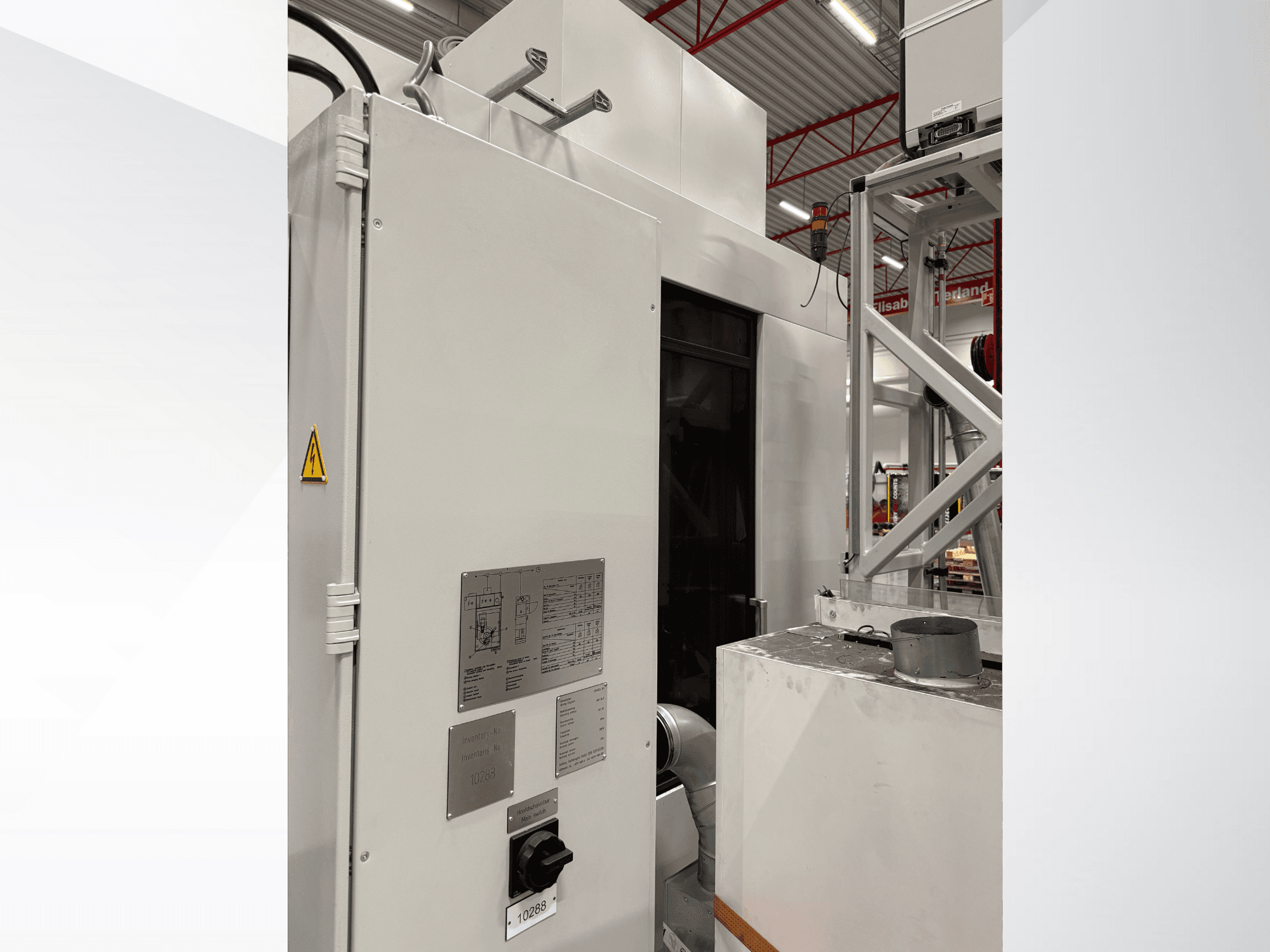 Вид збоку на білу промислову машину з панеллю керування та попереджувальною етикеткою, що є частиною автоматизованої системи.