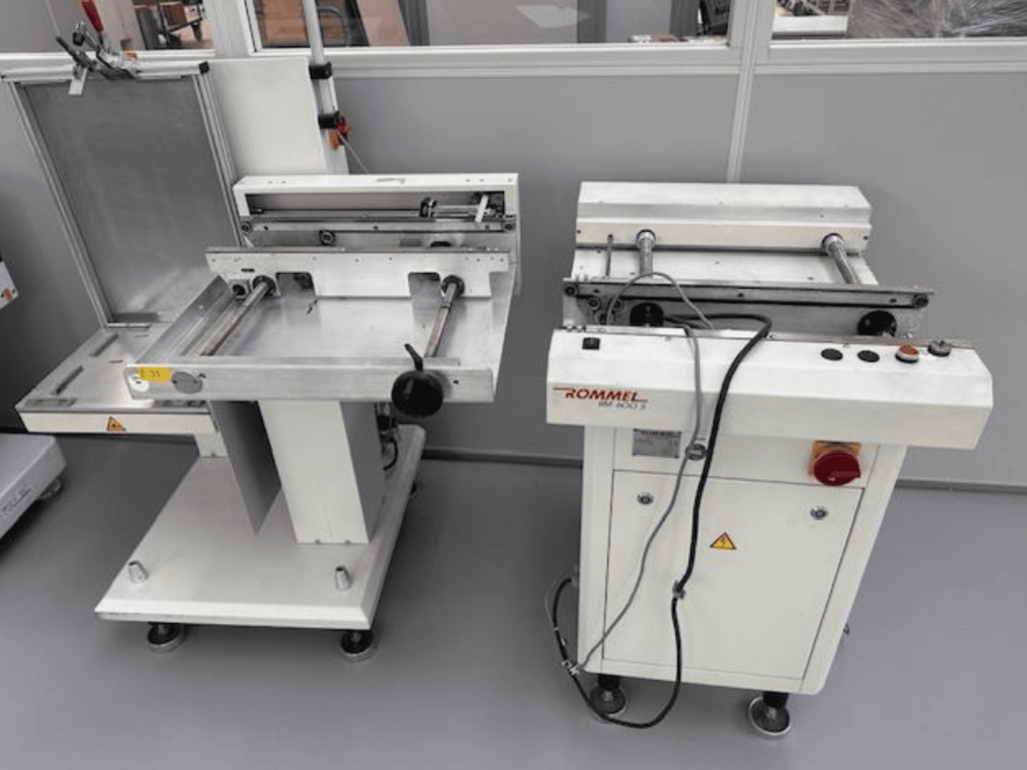 Етикетувальна машина Rommel HM 5033, вигляд спереду; оснащена панеллю керування, роликами та поверхнями з нержавіючої сталі.