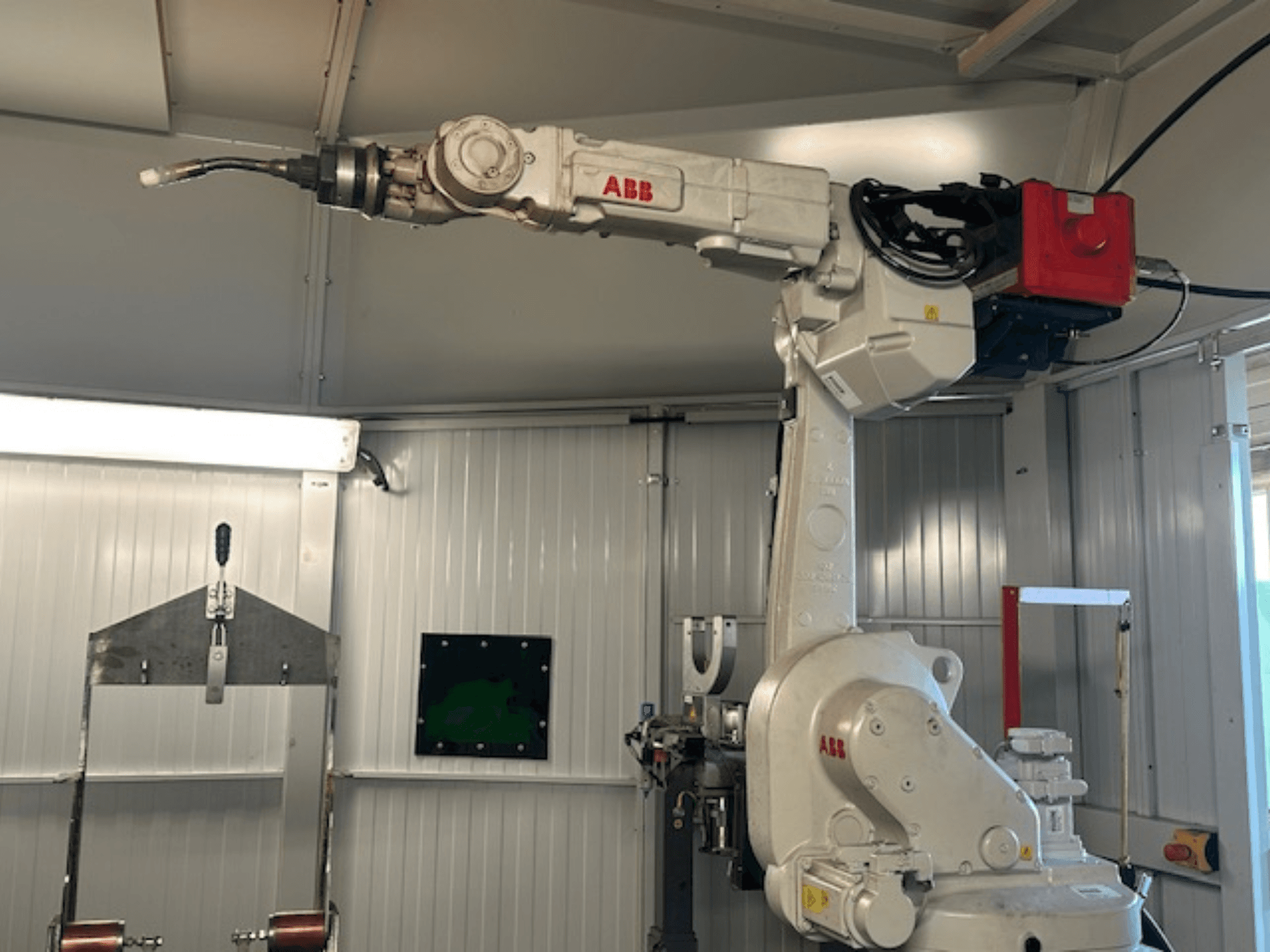 ABB Schweißroboter Flex Arc - вид збоку роботизованої руки зі зварювальним інструментом, демонструючи такі деталі, як панель керування та кабелі.