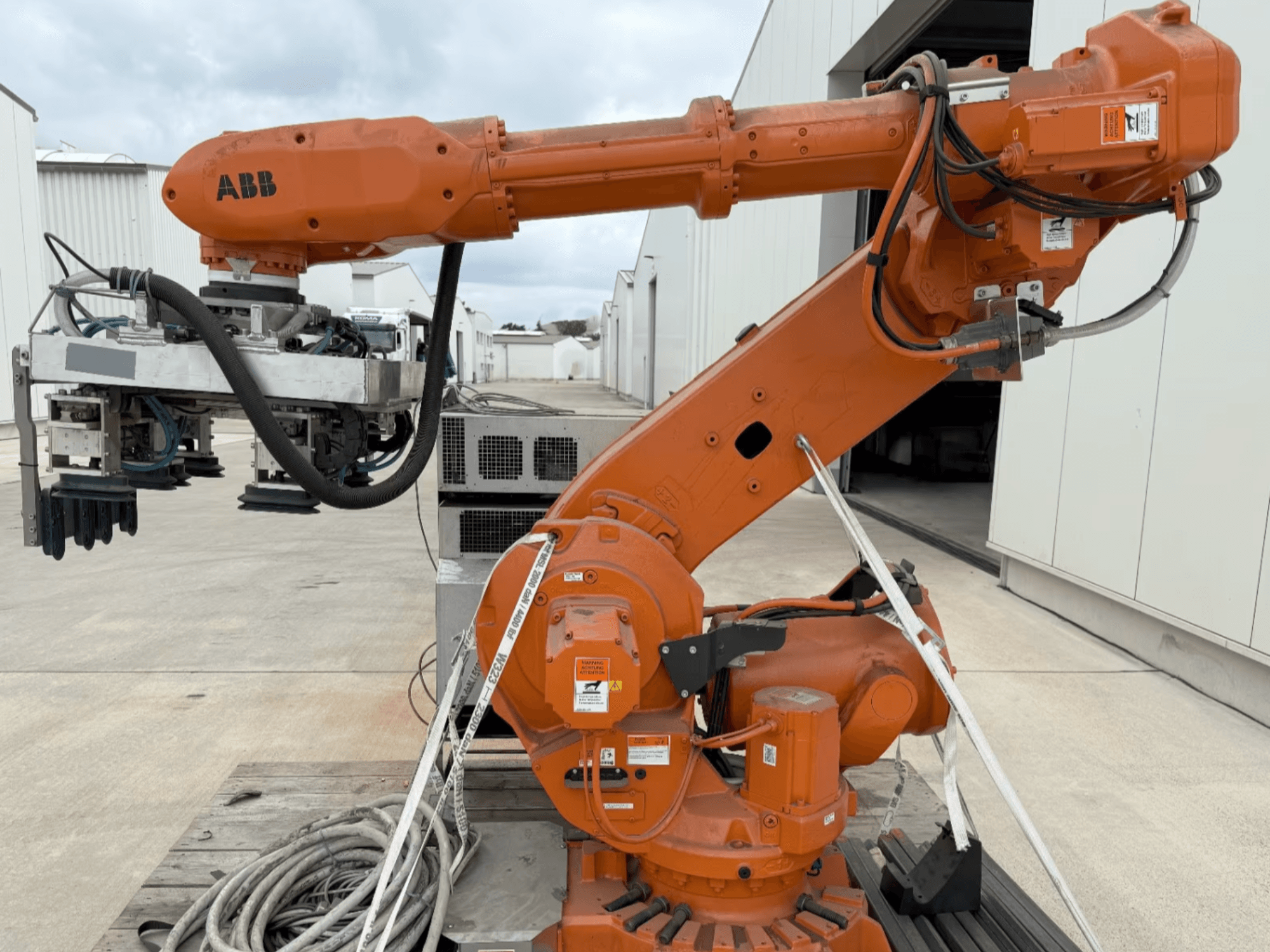 Роботизована рука ABB RB 6600-130/3.2 у вигляді збоку, з помаранчевою роботизованою рукою з насадкою для захоплення та видимою проводкою.