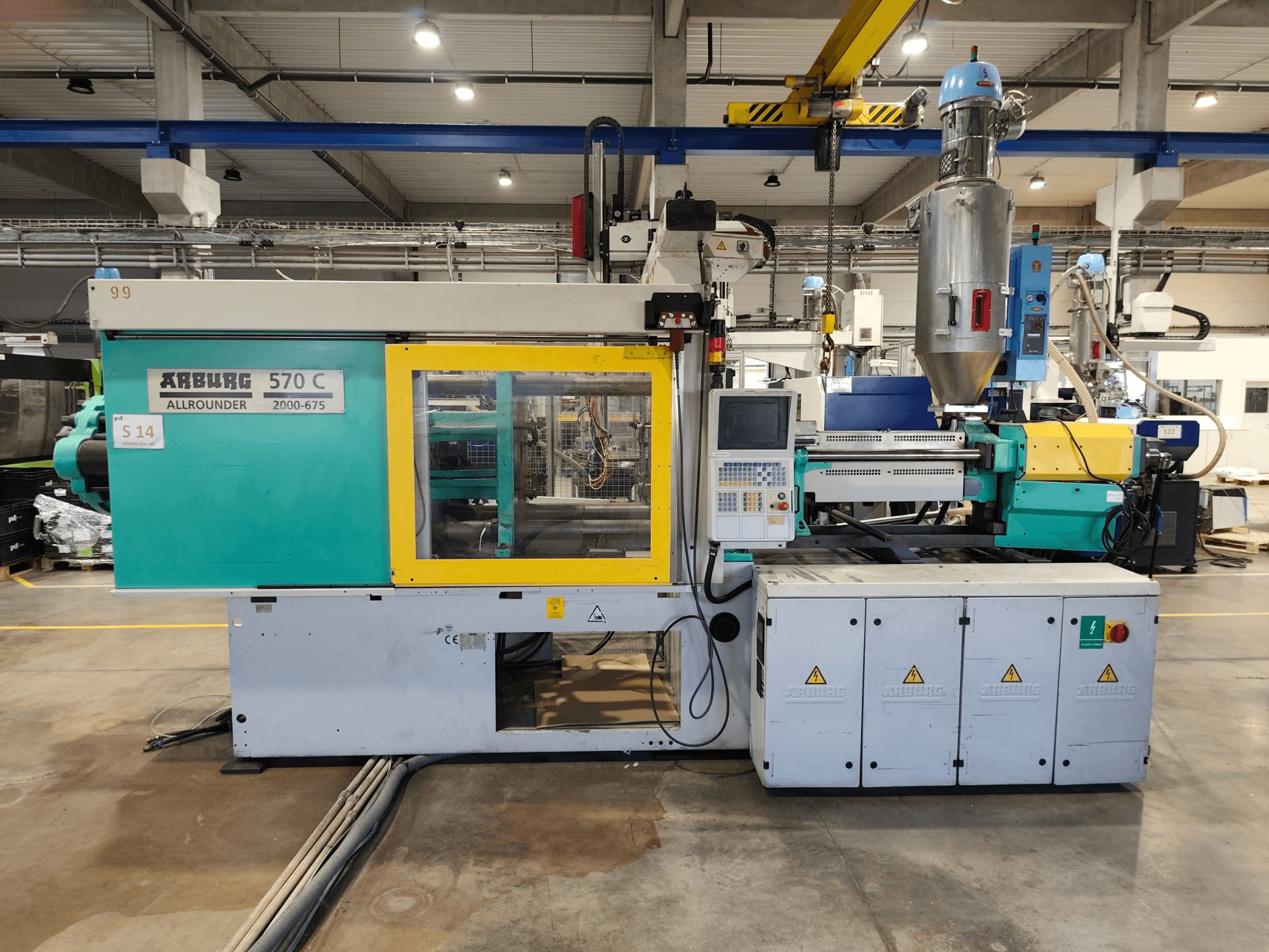 Гідравлічна термопластавтомат Arburg Allrounder 570 C 2000-675, вид спереду, з панеллю керування та бункером для сировини.