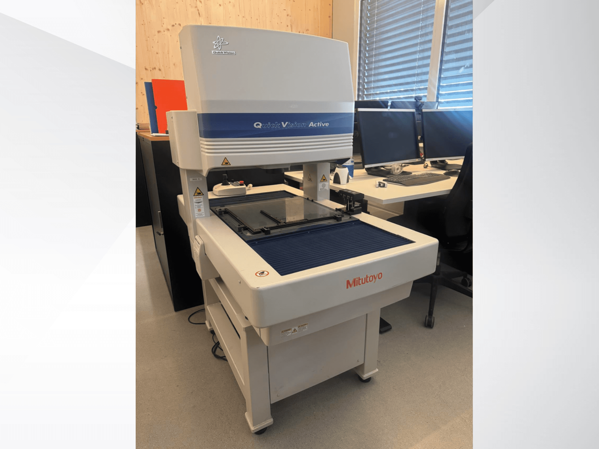 КВМ Mitutoyo QV-L404Z1L-D у вигляді спереду, зі скляним вимірювальним столом і видимою панеллю керування з кнопками.